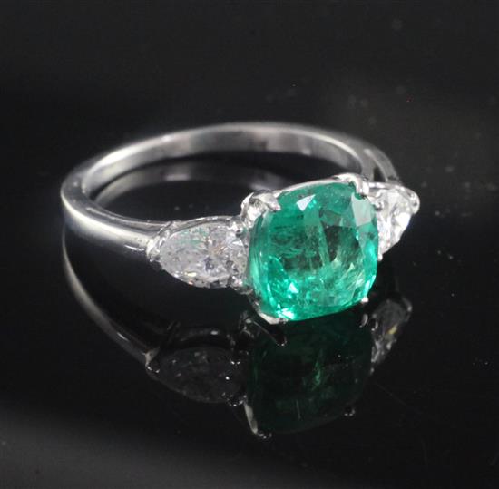 A platinum and iridium, three stone Columbian emerald and diamond ring, size M.
